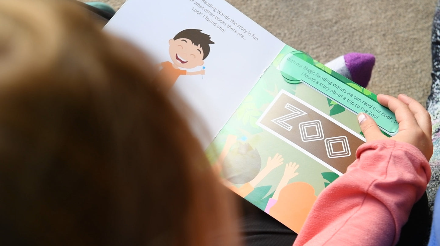Child reading a colorful book featuring the word 'ZOO' with cartoon illustrations, promoting literacy and engagement.